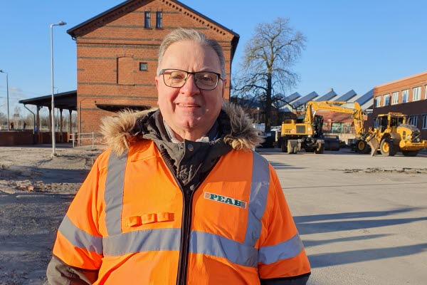 En person i orange reflexväst fram stationen i Svedala. Foto.